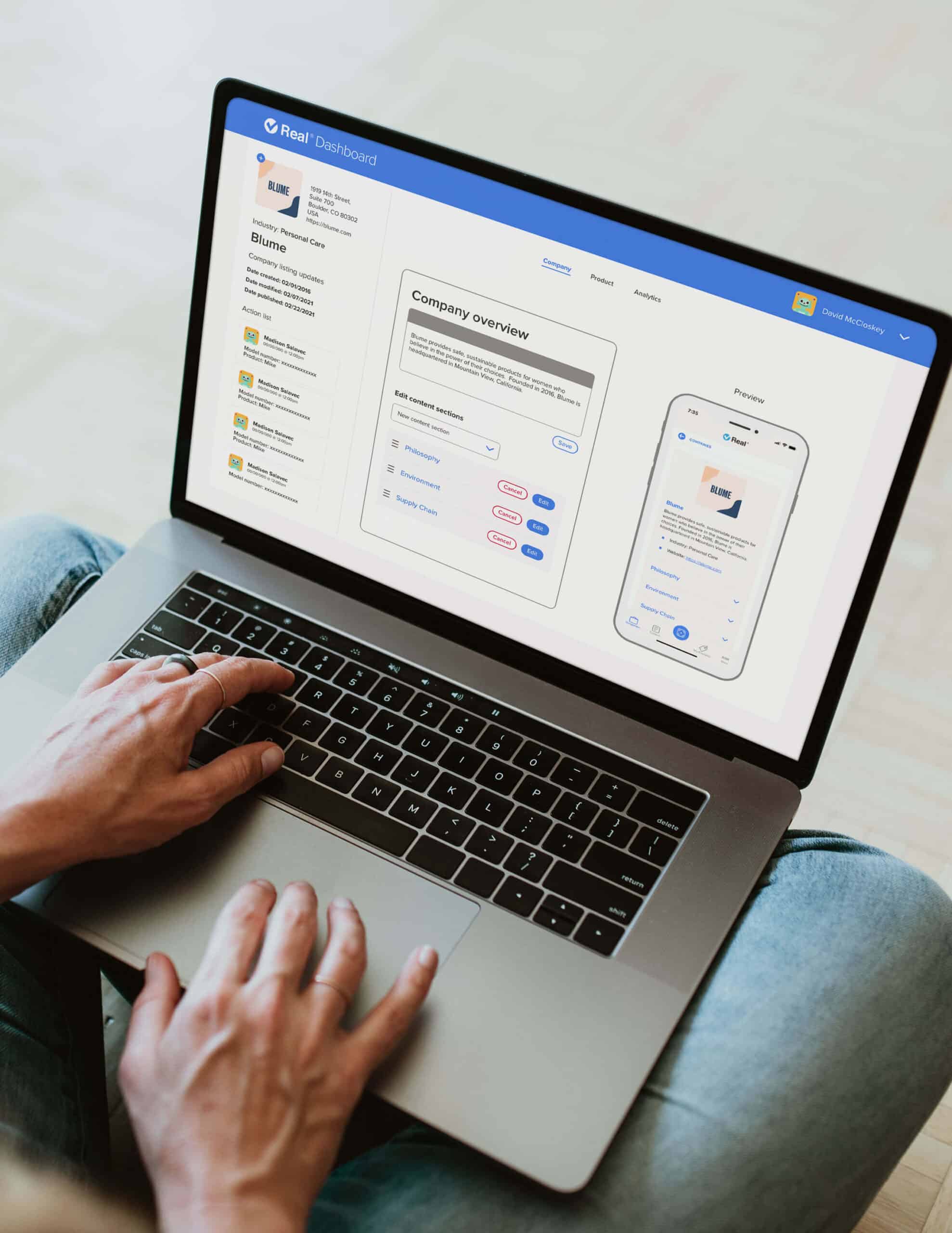 Woman working at a laptop using the Real® Brand Dashboard