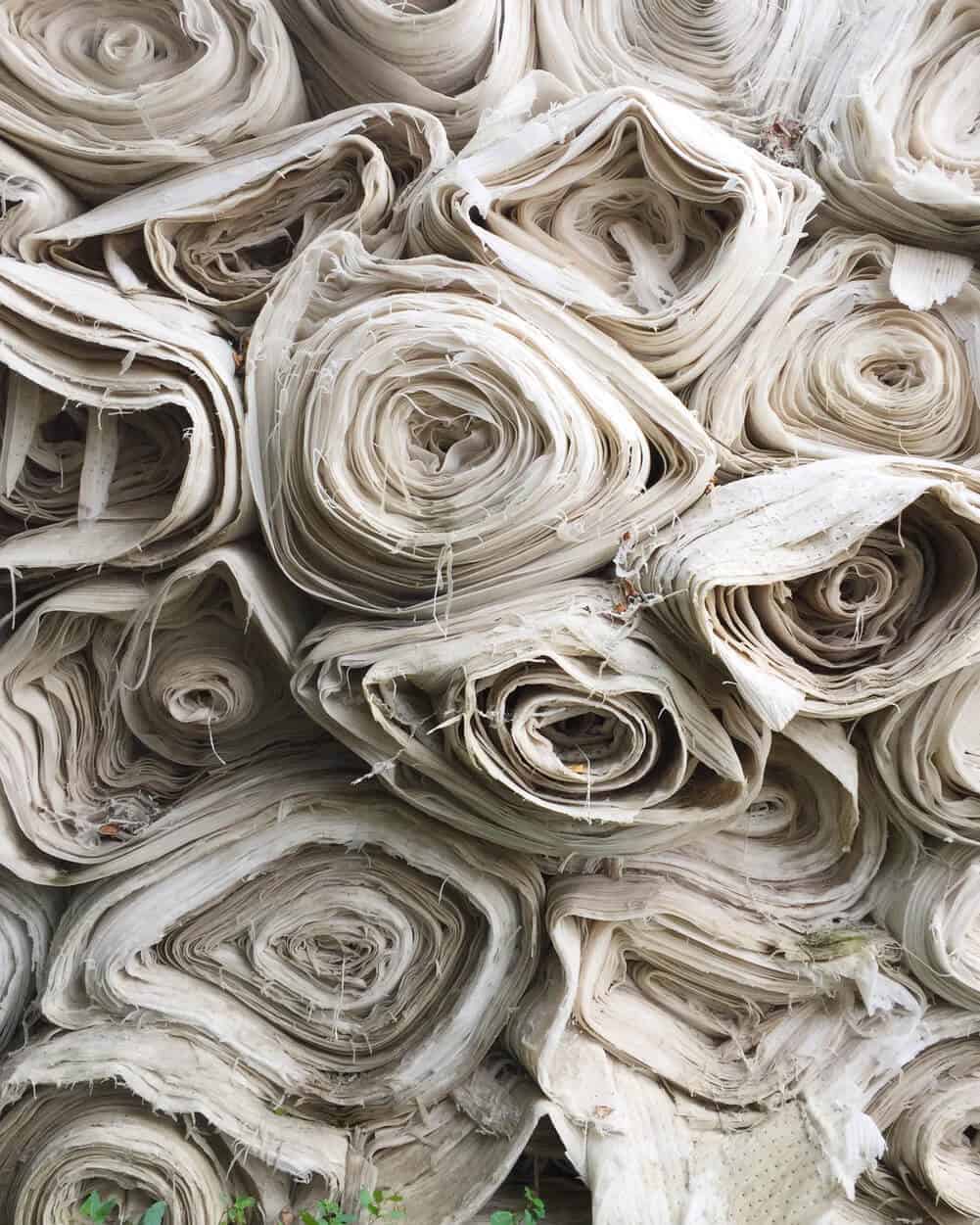 Large rolls of white textile fabric for manufacturing